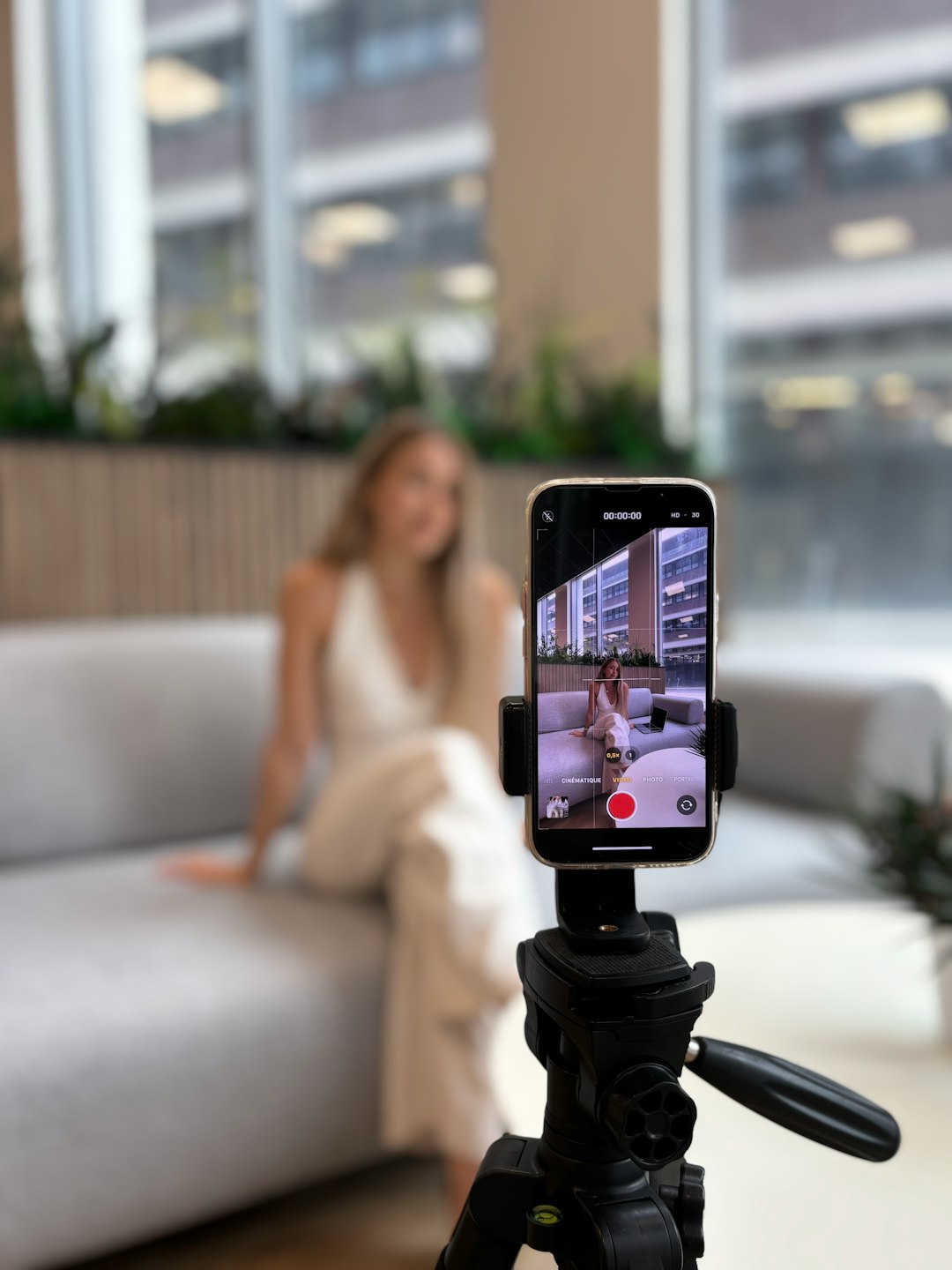 Woman recording herself on a smartphone tripod Woman recording herself on a smartphone tripod